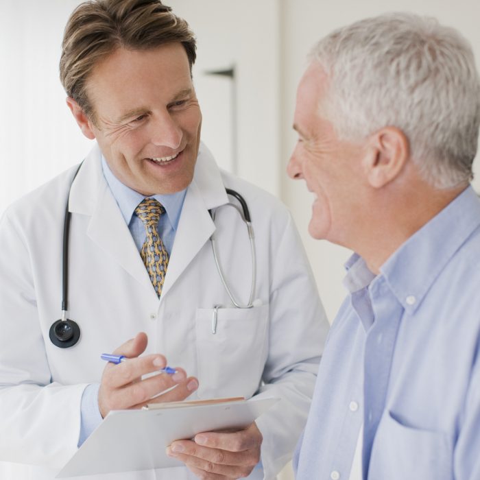Doctor talking with patient in doctors office