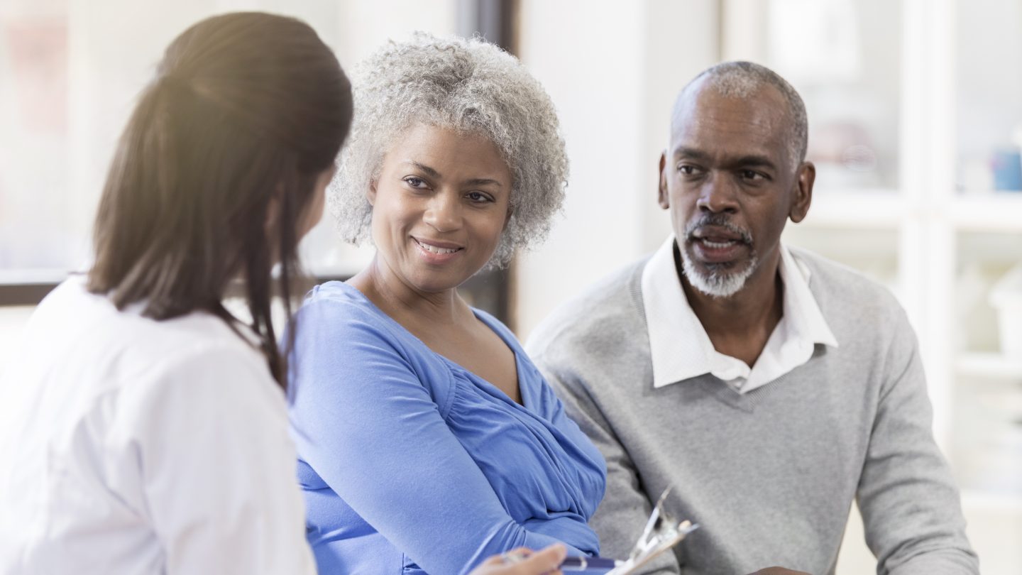 Couple speaking with physician