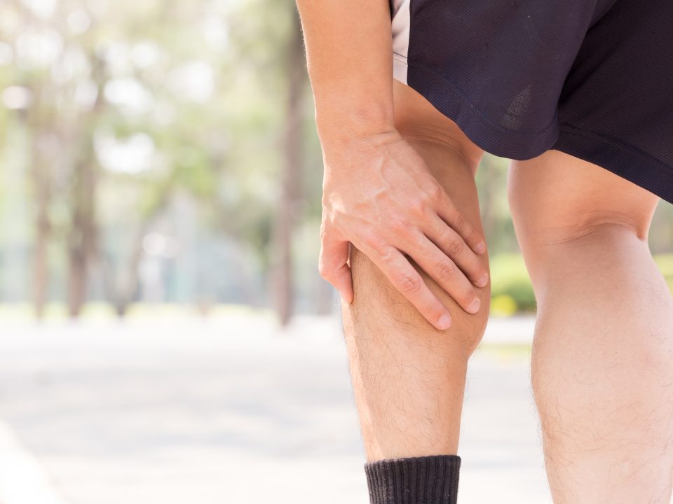 Man grasping leg