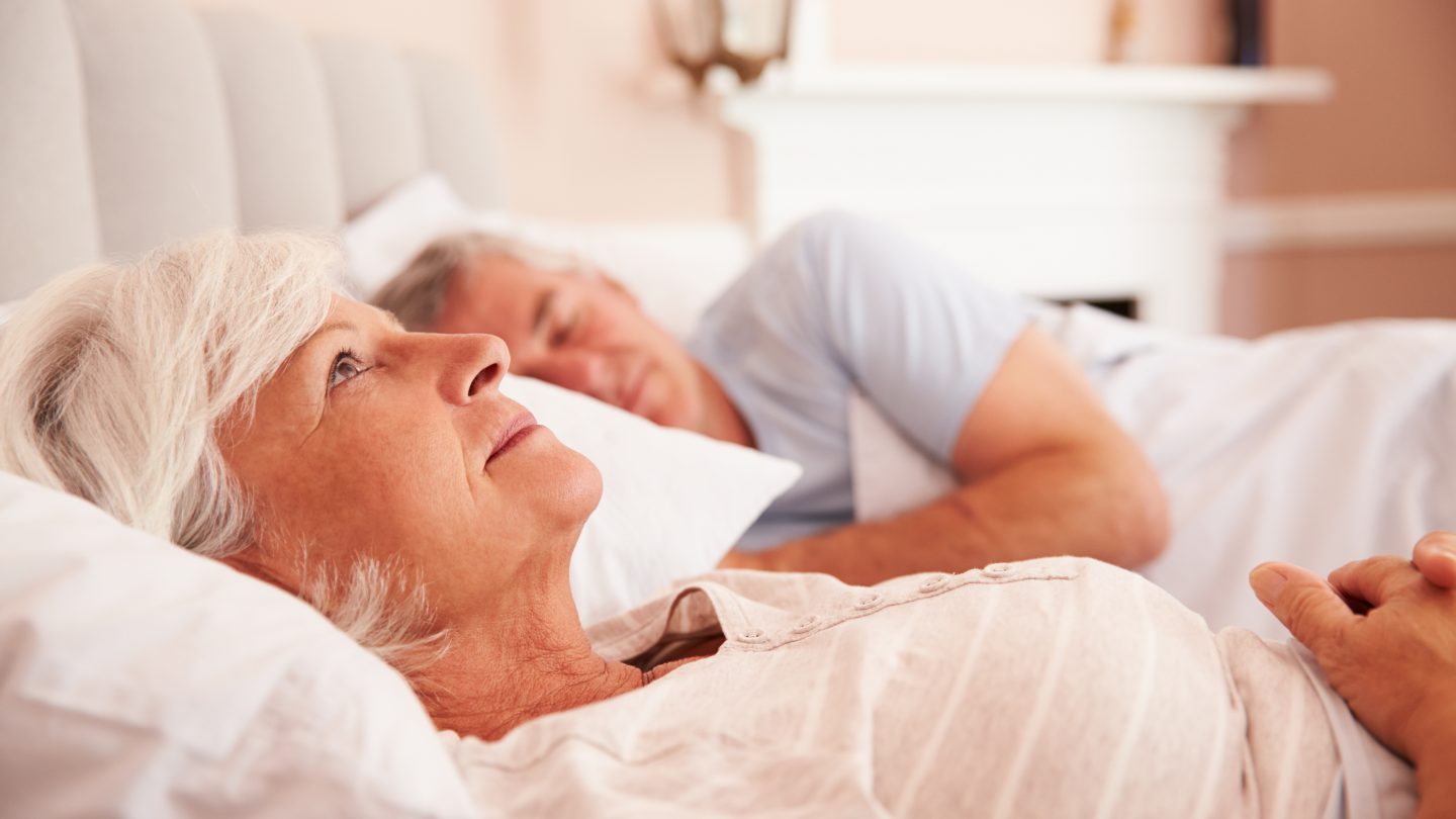 Woman lying awake in bed